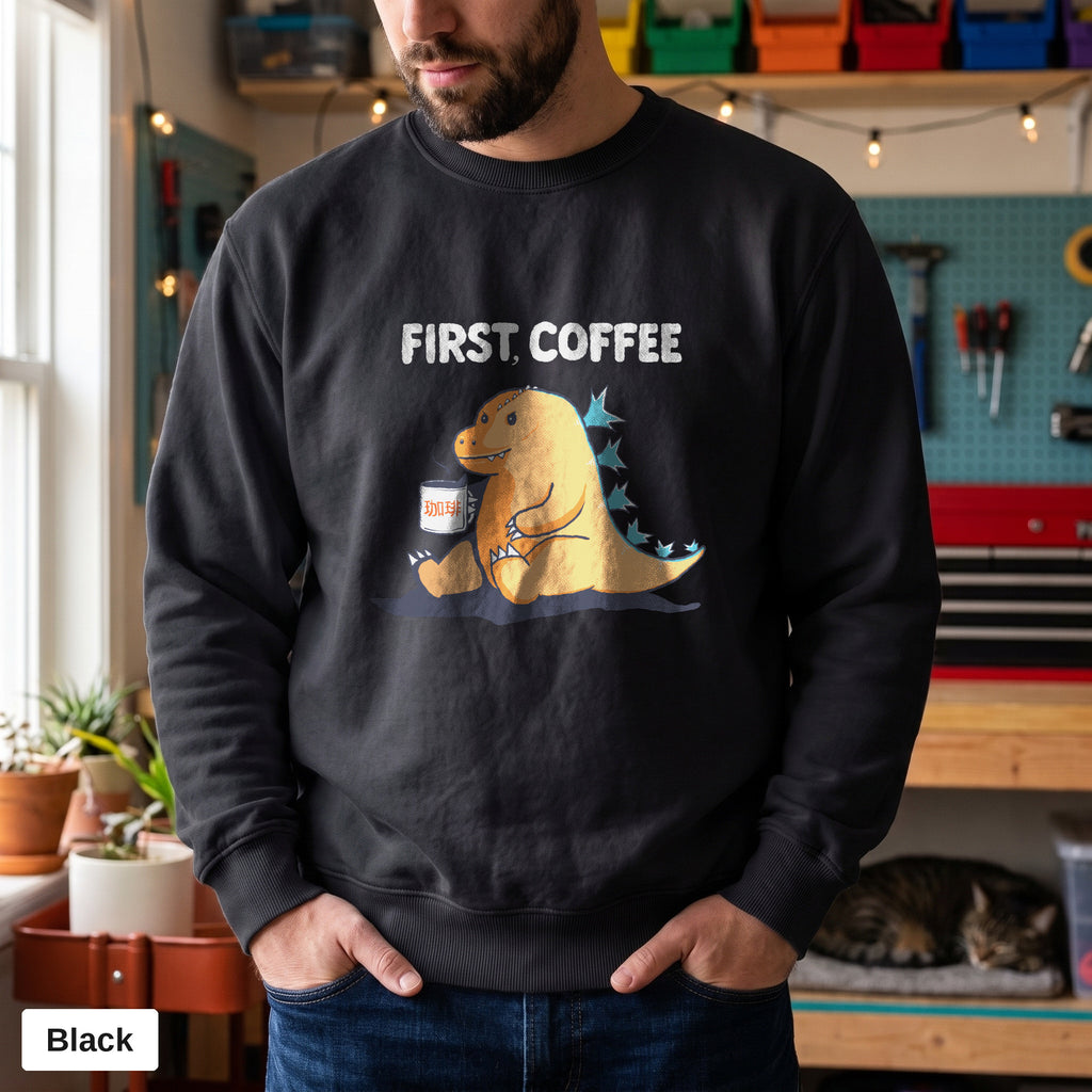 Black Comfort Colors crewneck sweatshirt worn by a man, First Coffee kaiju design printed on the chest