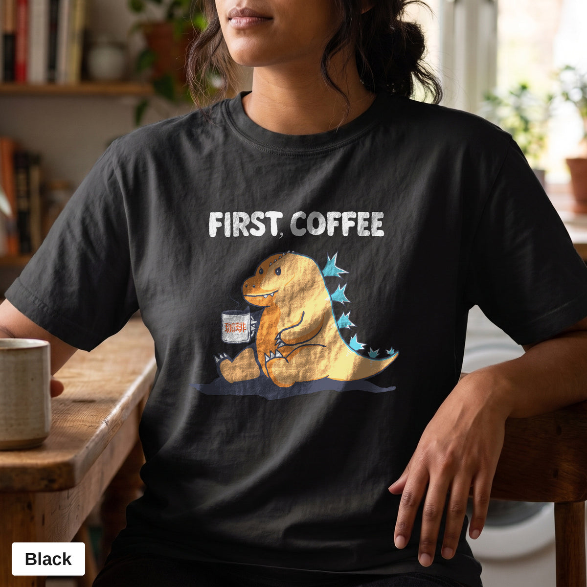 First Coffee dinosaur graphic tee, Comfort Colors 1717 in Black, worn