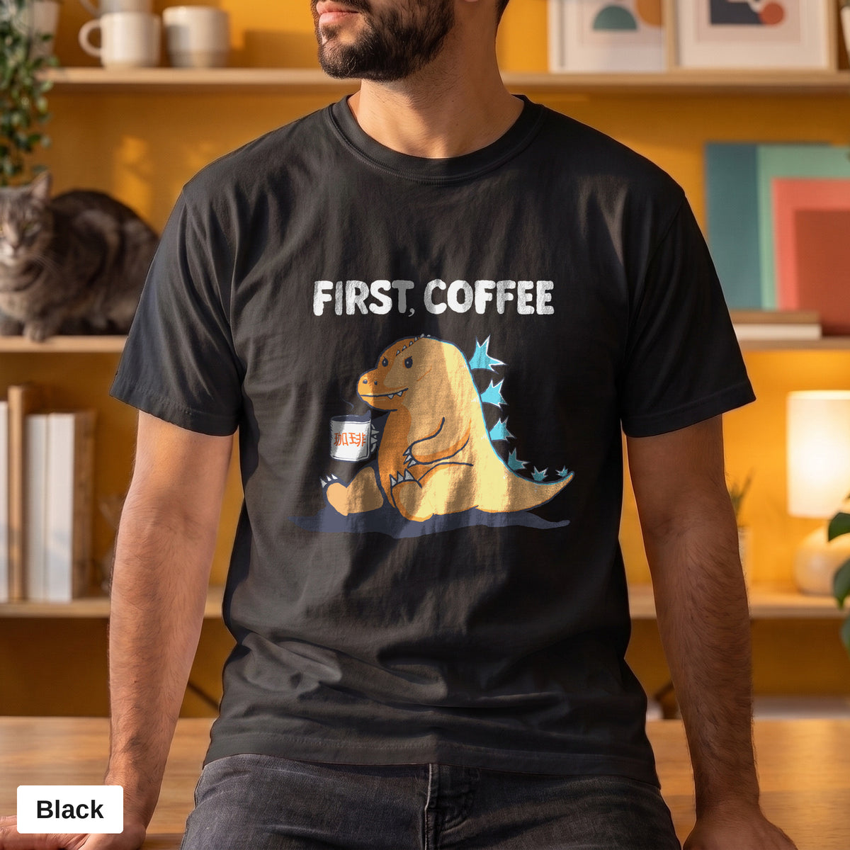 First Coffee dinosaur graphic tee, Comfort Colors 1717 in Black, worn by a man
