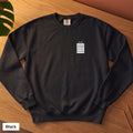 Black Comfort Colors crewneck sweatshirt, folded flat lay, 90% Cat Hair 10% Cotton design printed on the chest