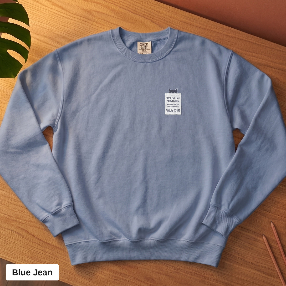 Blue Jean Comfort Colors crewneck sweatshirt, folded flat lay, 90% Cat Hair 10% Cotton design printed on the chest