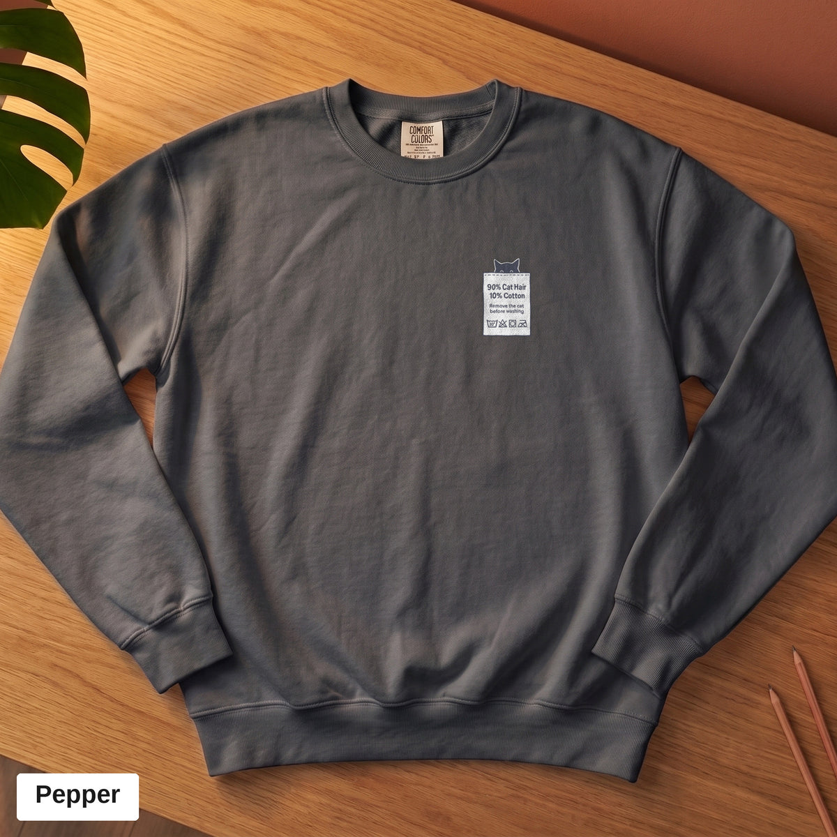 Pepper Comfort Colors crewneck sweatshirt, folded flat lay, 90% Cat Hair 10% Cotton design printed on the chest