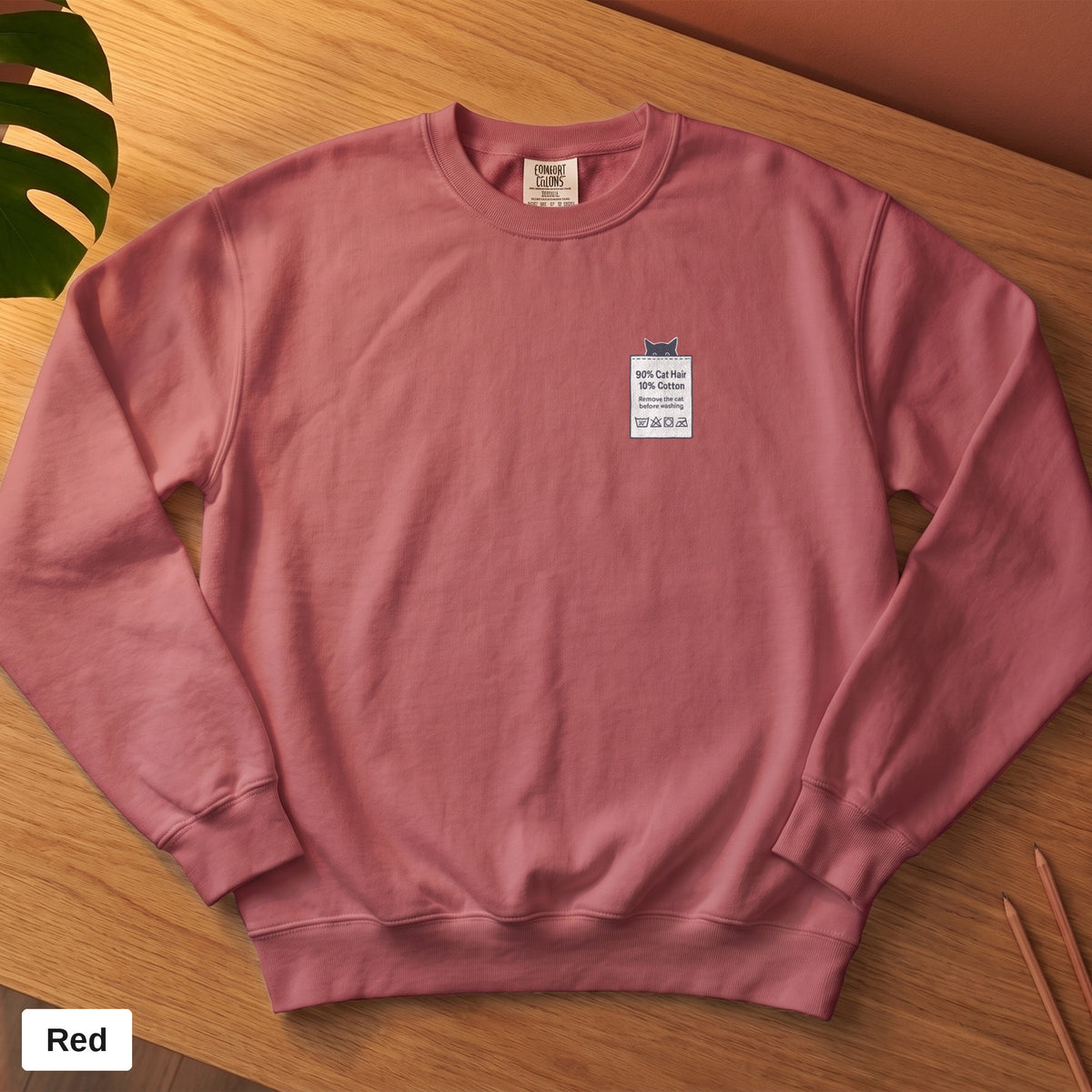Crimson Comfort Colors crewneck sweatshirt, folded flat lay, 90% Cat Hair 10% Cotton design printed on the chest