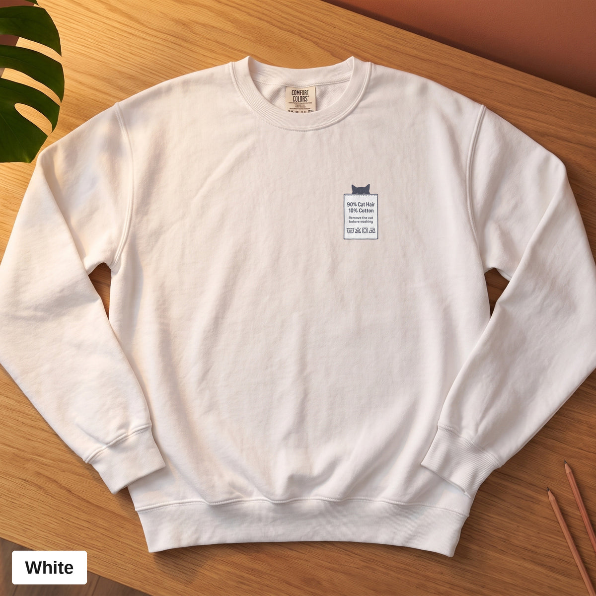 White Comfort Colors crewneck sweatshirt, folded flat lay, 90% Cat Hair 10% Cotton design printed on the chest