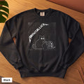 Black Comfort Colors crewneck sweatshirt, folded flat lay, metal cat and snake design printed on the chest