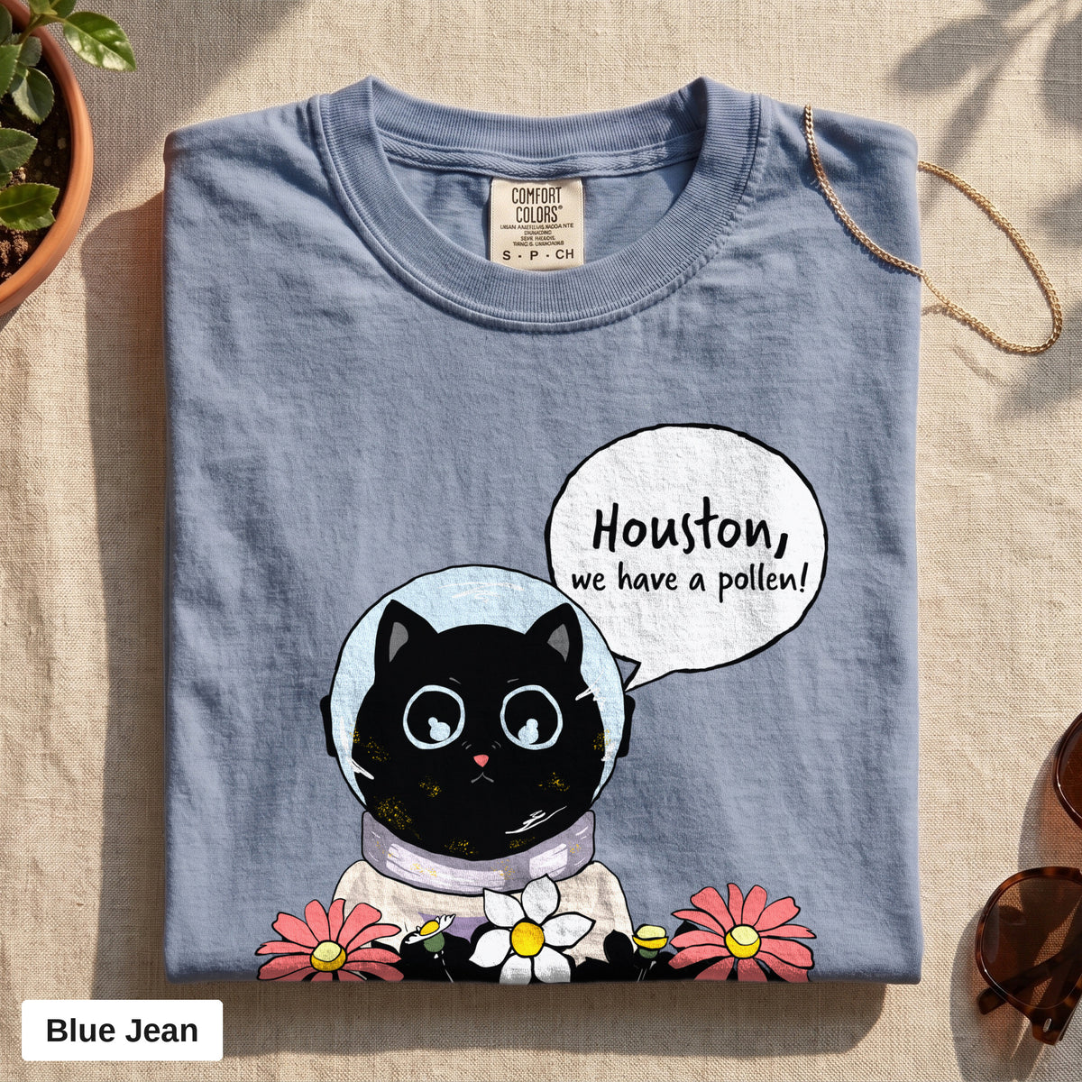 Houston We Have A Pollen cat astronaut tee, Comfort Colors 1717 in Blue Jean, folded flat lay