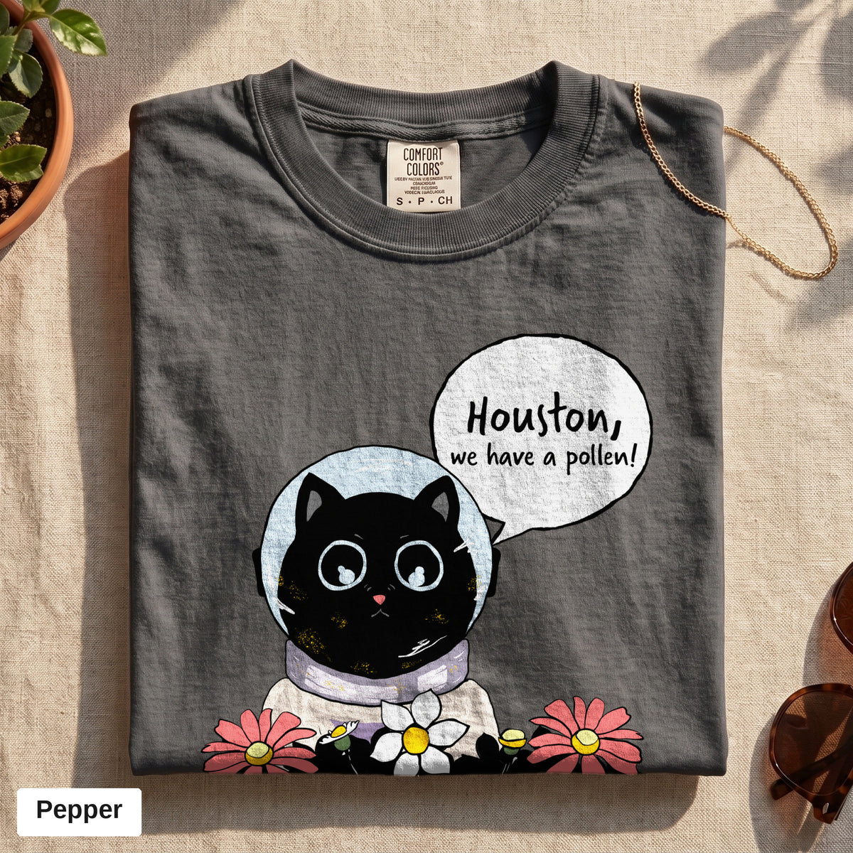 Houston We Have A Pollen cat astronaut tee, Comfort Colors 1717 in Pepper, folded flat lay