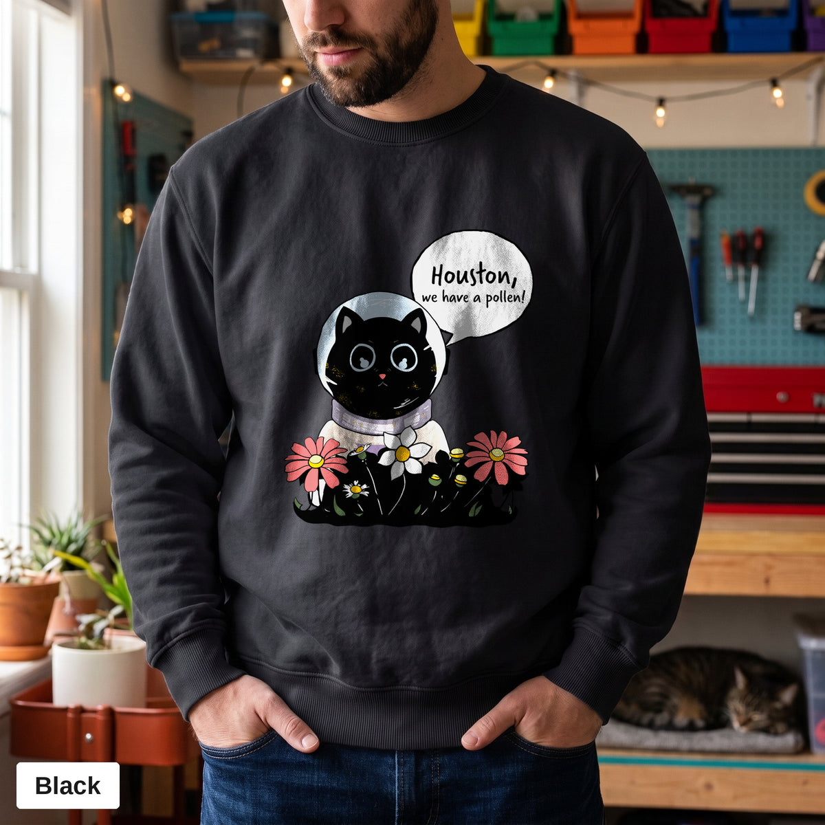 Black Comfort Colors crewneck sweatshirt worn by a man, Houston We Have A Pollen cat astronaut design printed on the chest