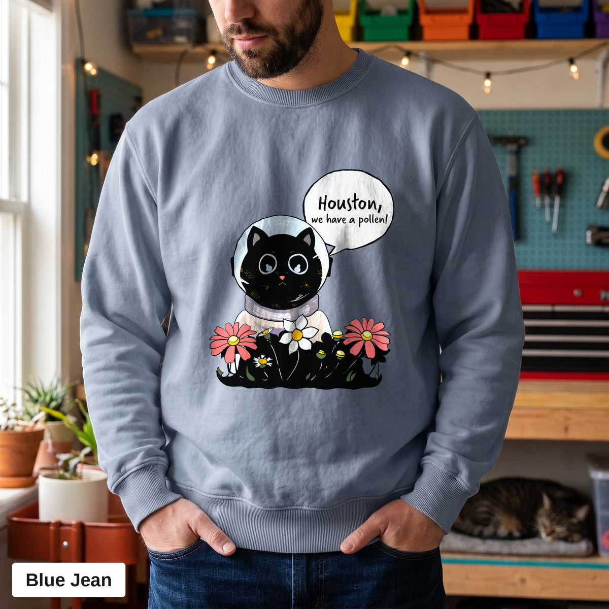 Blue Jean Comfort Colors crewneck sweatshirt worn by a man, Houston We Have A Pollen cat astronaut design printed on the chest