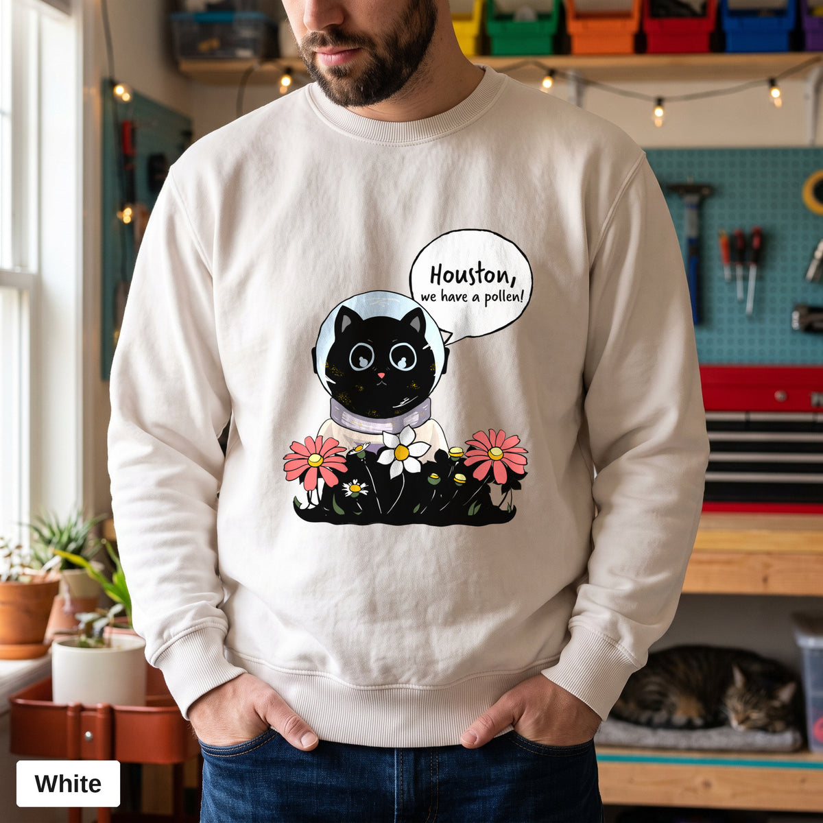 White Comfort Colors crewneck sweatshirt worn by a man, Houston We Have A Pollen cat astronaut design printed on the chest