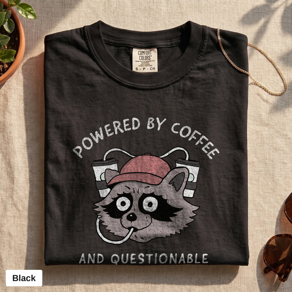 Powered By Coffee And Questionable Life Choices raccoon tee, Comfort Colors 1717 in Black, folded flat lay