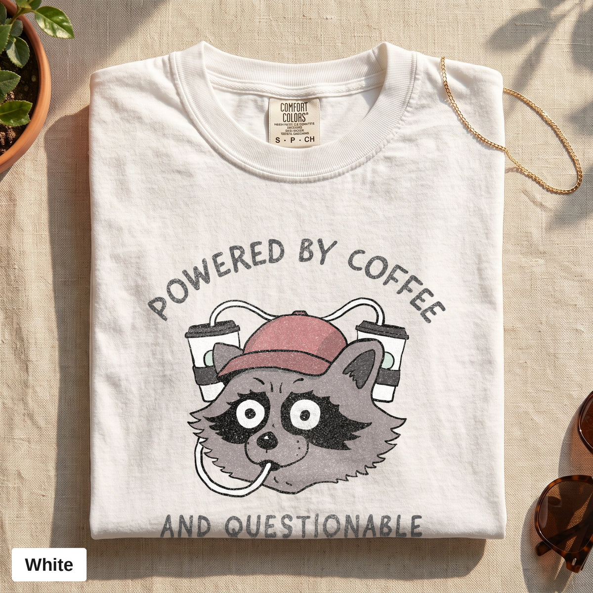 Powered By Coffee And Questionable Life Choices raccoon tee, Comfort Colors 1717 in White, folded flat lay