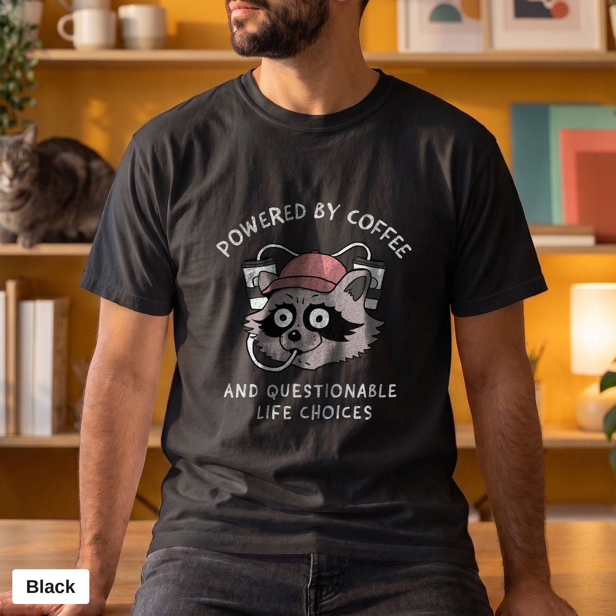 Powered By Coffee And Questionable Life Choices raccoon tee, Comfort Colors 1717 in Black, worn by a man