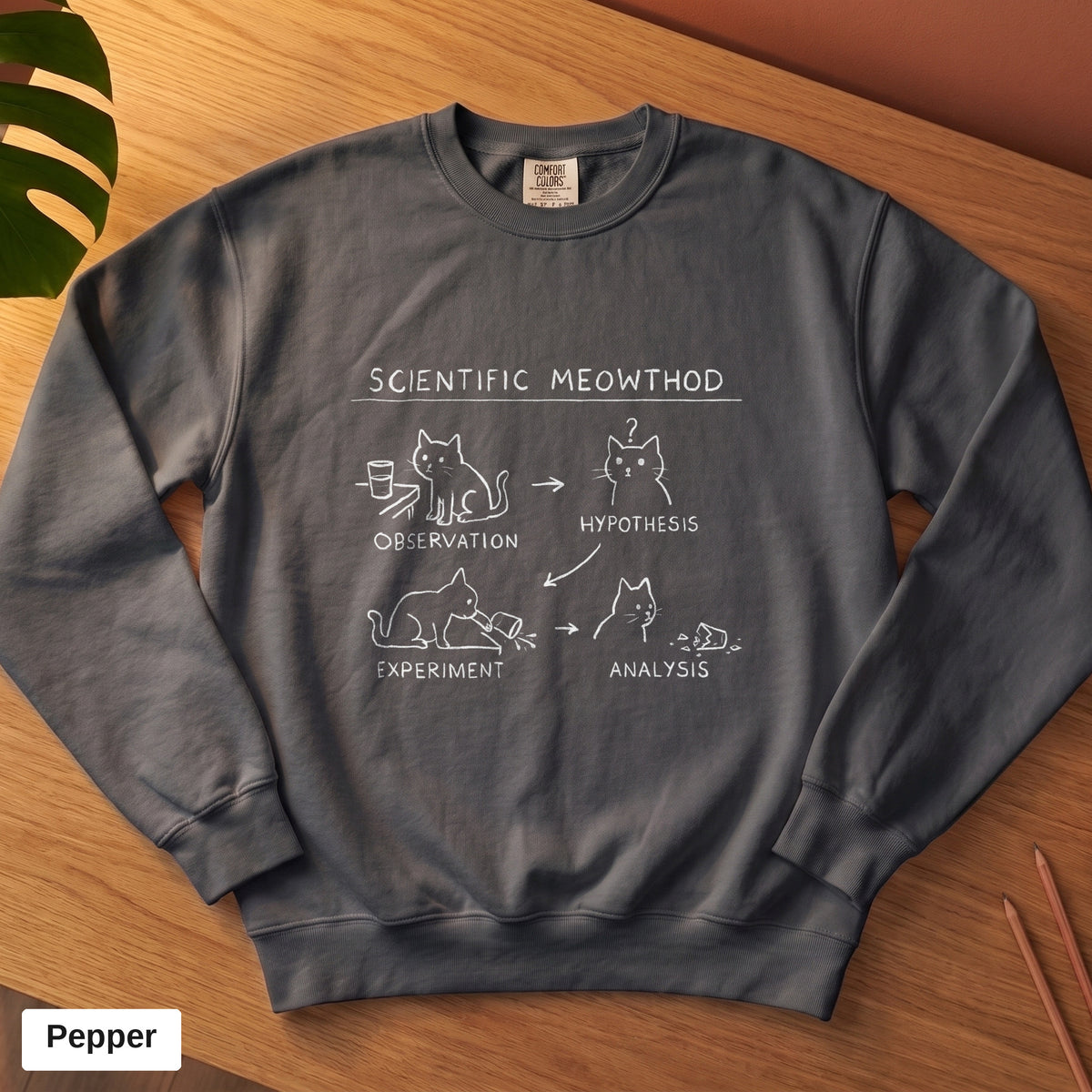 Pepper Comfort Colors crewneck sweatshirt, folded flat lay, Scientific Meowthod cat science diagram printed on the chest