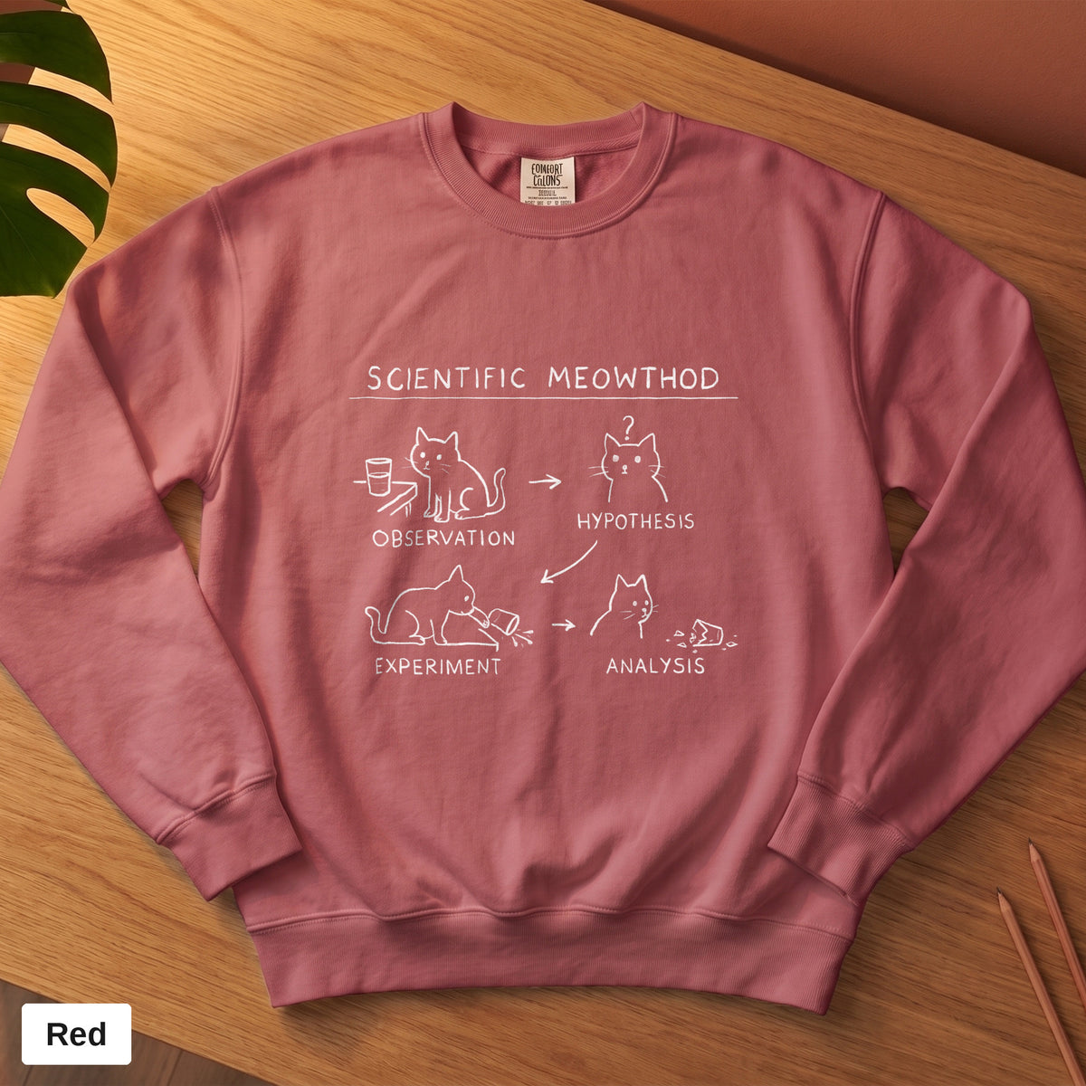 Crimson Comfort Colors crewneck sweatshirt, folded flat lay, Scientific Meowthod cat science diagram printed on the chest