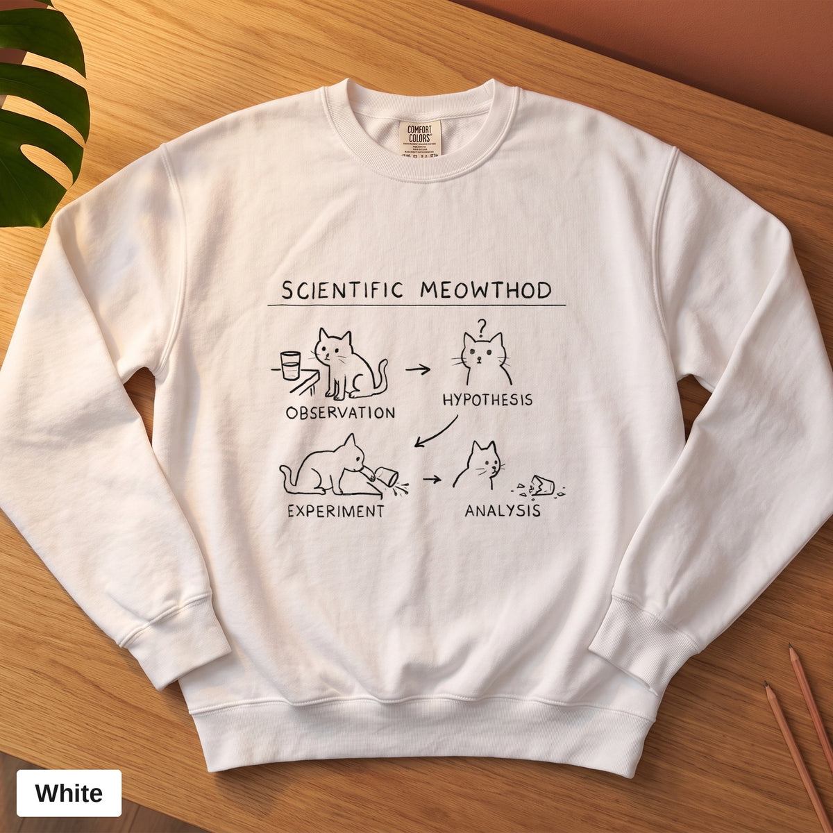 White Comfort Colors crewneck sweatshirt, folded flat lay, Scientific Meowthod cat science diagram printed on the chest