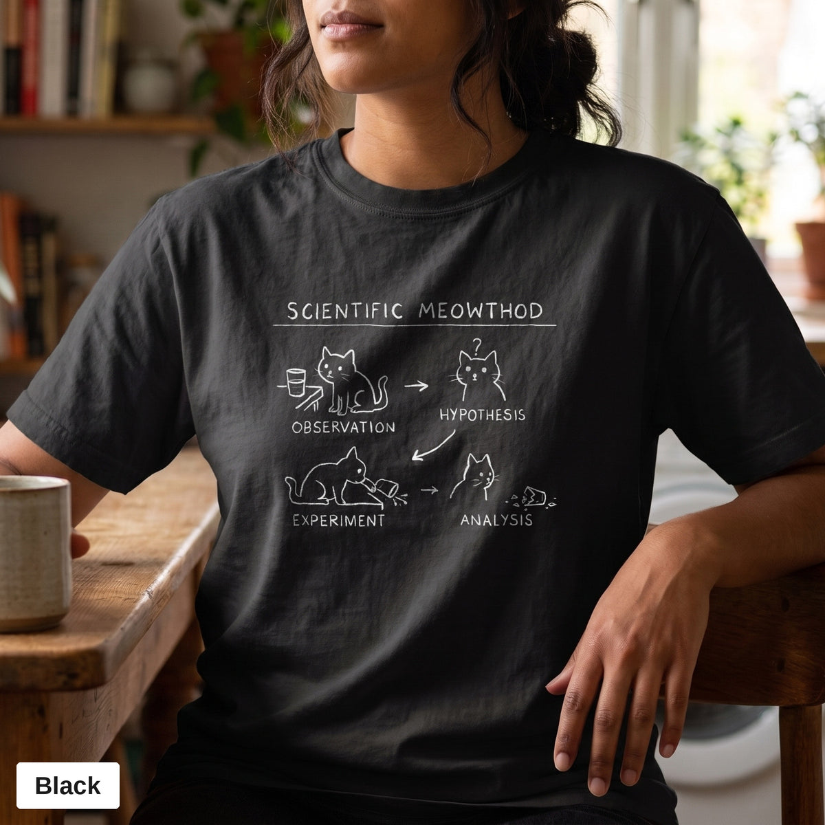 Scientific Meowthod cat science diagram tee, Comfort Colors 1717 in Black, worn by a woman