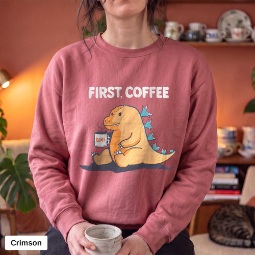 Crimson Comfort Colors crewneck sweatshirt worn by a model, First Coffee kaiju design printed on the chest