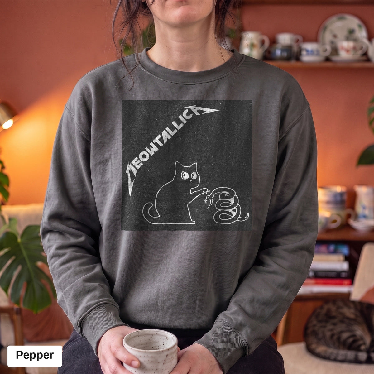 Pepper Comfort Colors crewneck sweatshirt worn by a model, metal cat and snake design printed on the chest