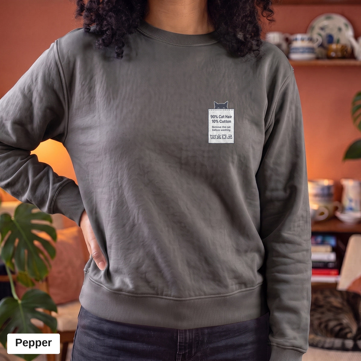 Pepper Comfort Colors crewneck sweatshirt worn by a model, 90% Cat Hair 10% Cotton design printed on the chest