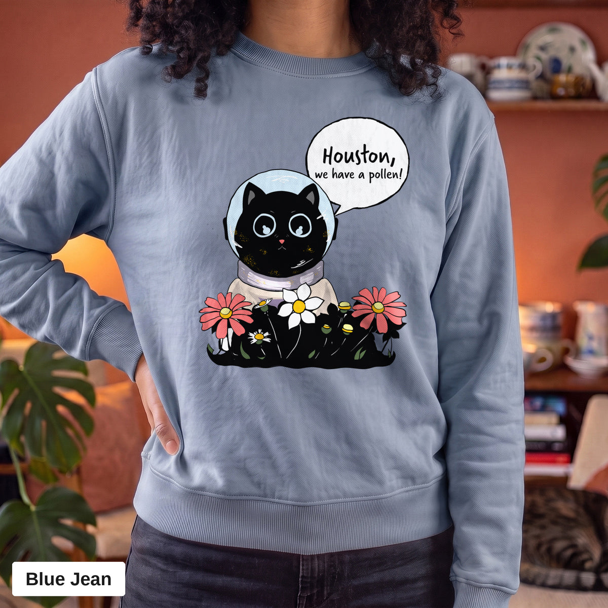 Blue Jean Comfort Colors crewneck sweatshirt worn by a model, Houston We Have A Pollen cat astronaut design printed on the chest