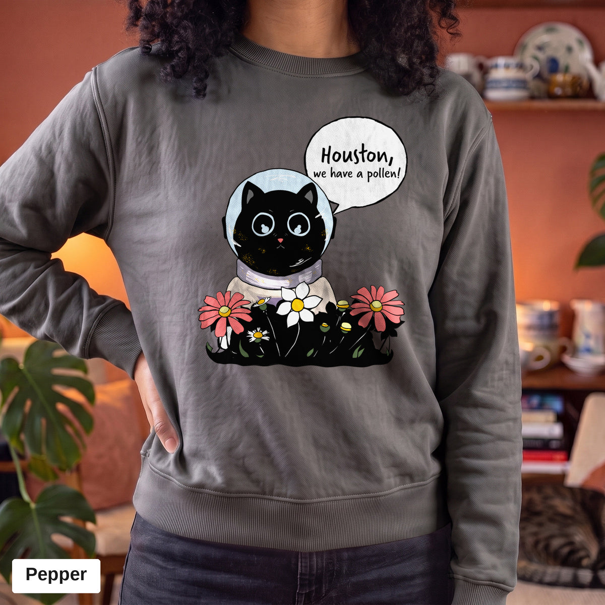 Pepper Comfort Colors crewneck sweatshirt worn by a model, Houston We Have A Pollen cat astronaut design printed on the chest