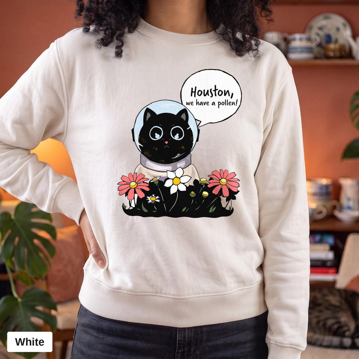 White Comfort Colors crewneck sweatshirt worn by a model, Houston We Have A Pollen cat astronaut design printed on the chest