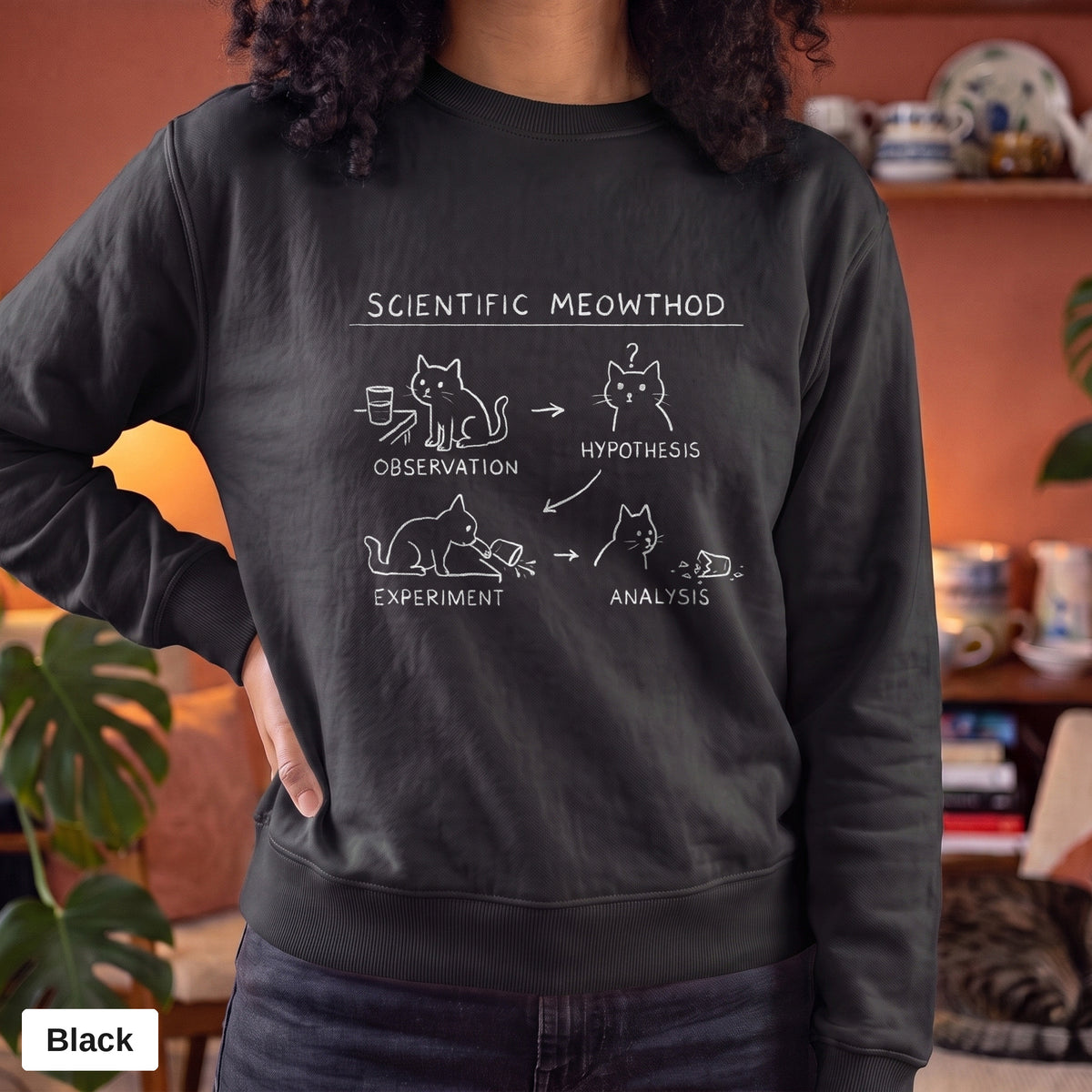 Black Comfort Colors crewneck sweatshirt worn by a model, Scientific Meowthod cat science diagram printed on the chest