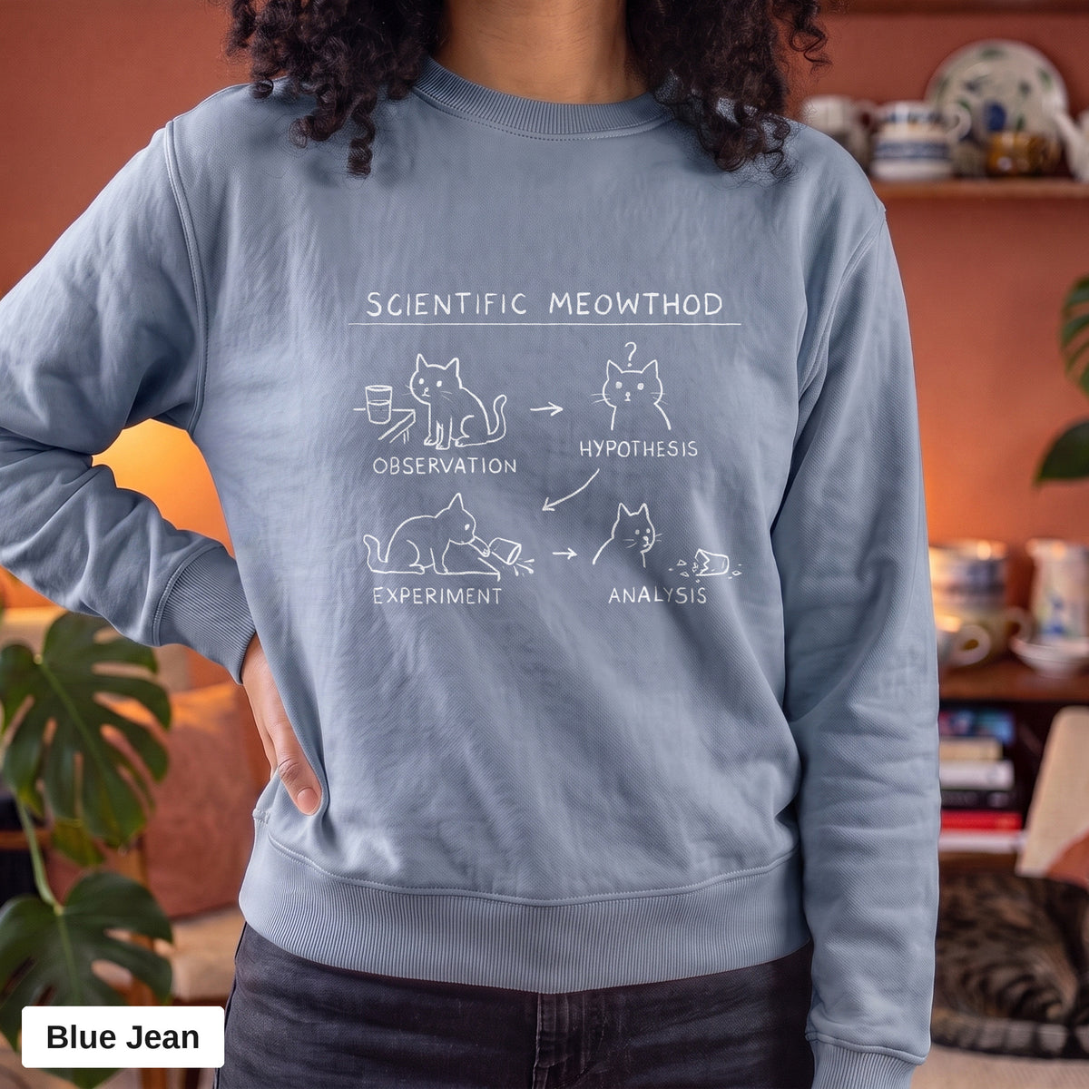 Blue Jean Comfort Colors crewneck sweatshirt worn by a model, Scientific Meowthod cat science diagram printed on the chest